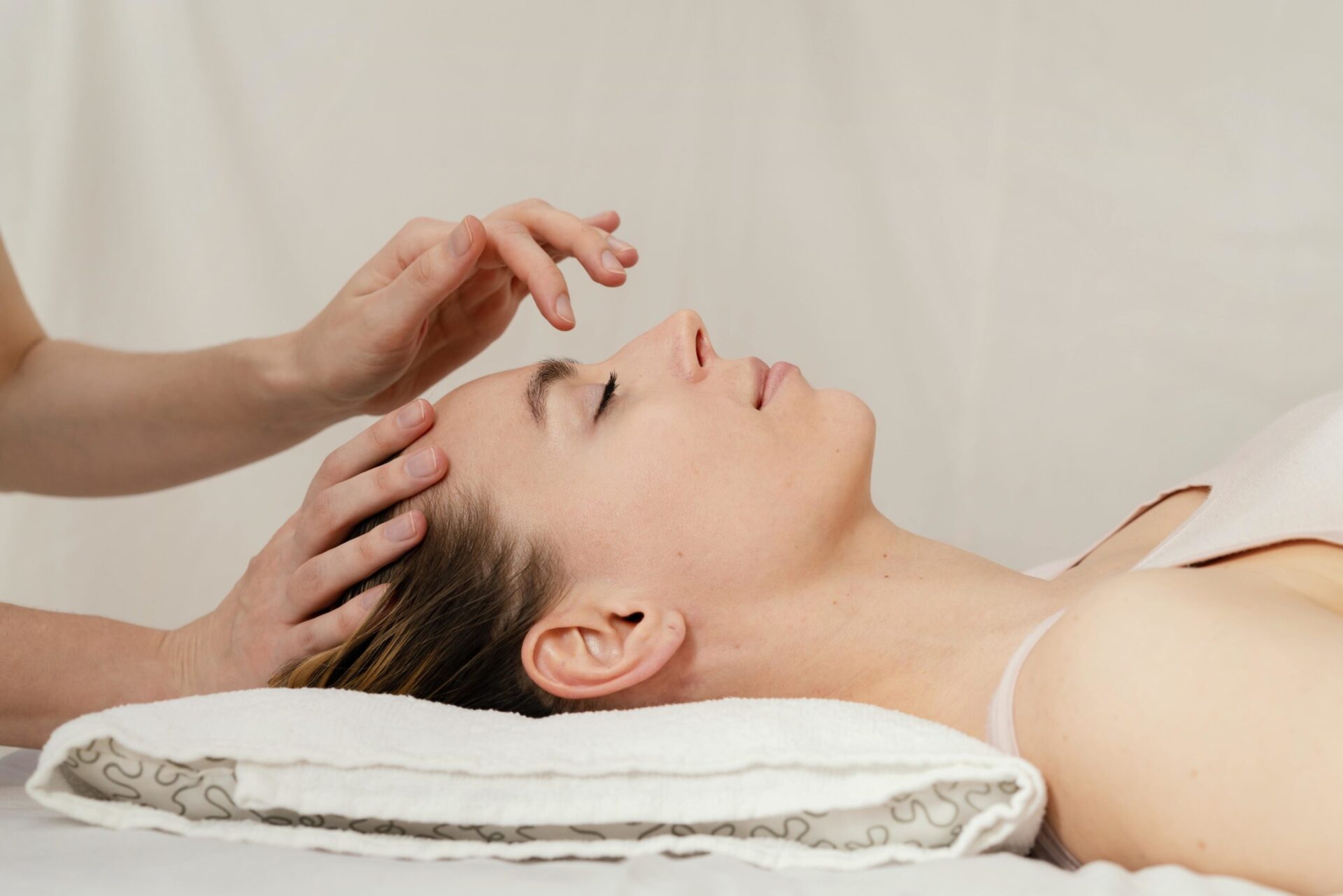oakville facial acupuncture for skin care hands on face of woman